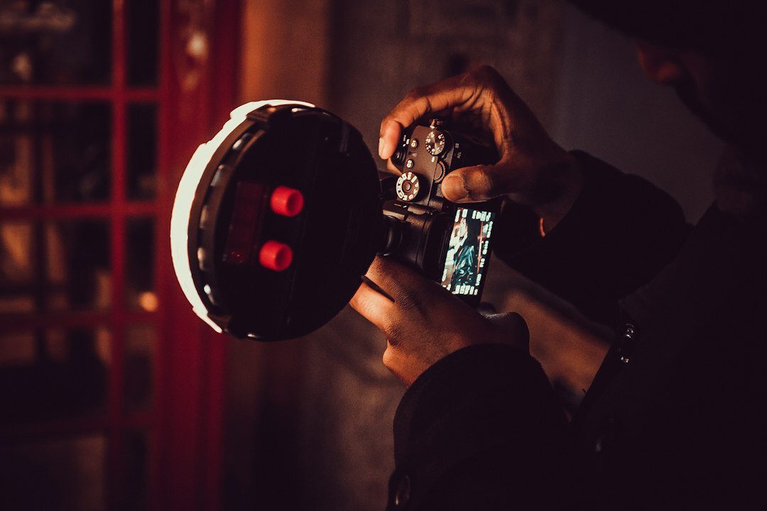 Camera operator adjusting a broadcast camera during a live news segment